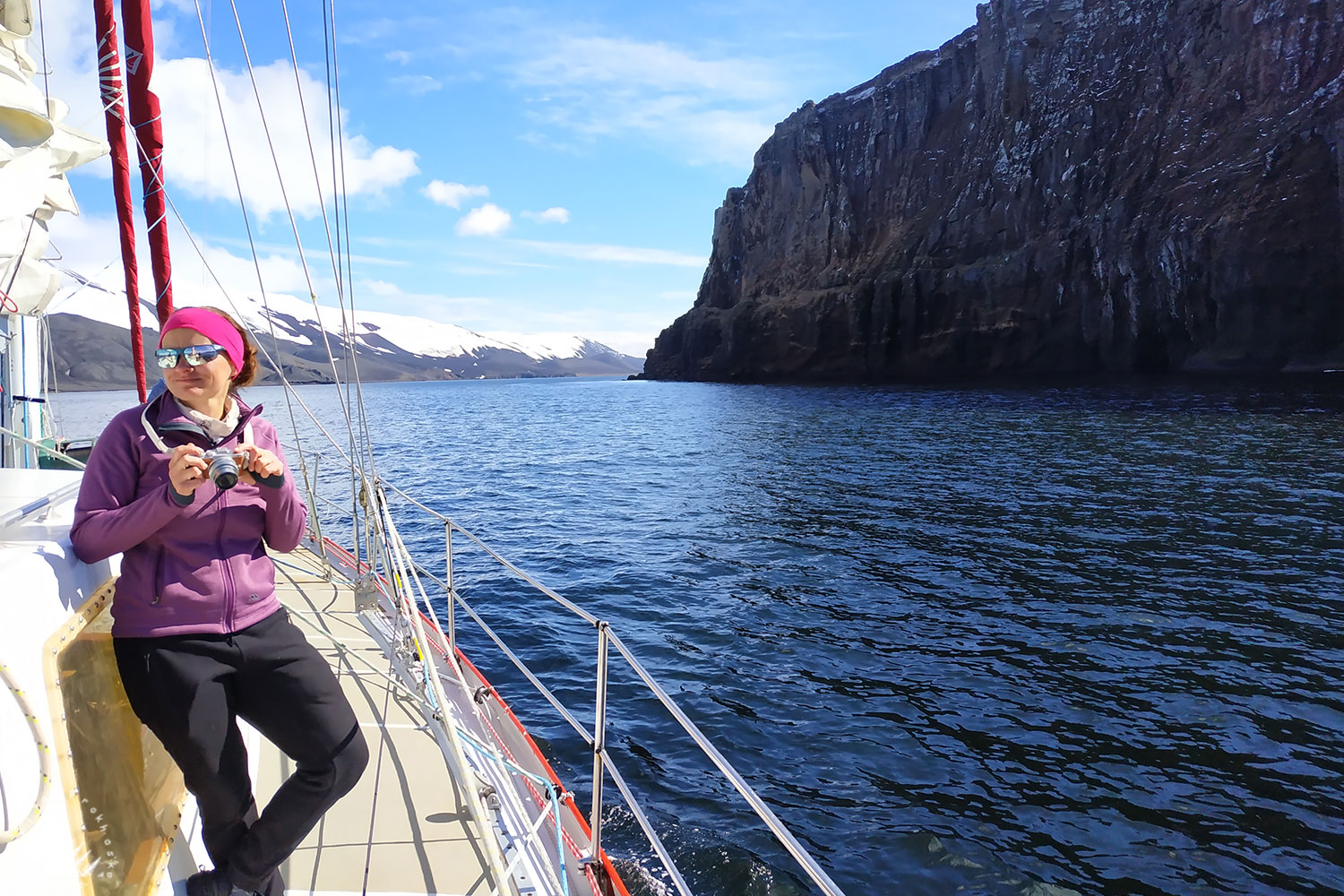 Yacht reaching volcanic island